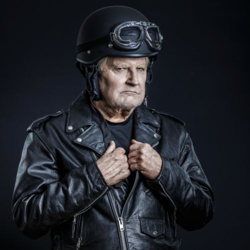 Man wearing vintage biker helmet and classic leather motorcycle jacket